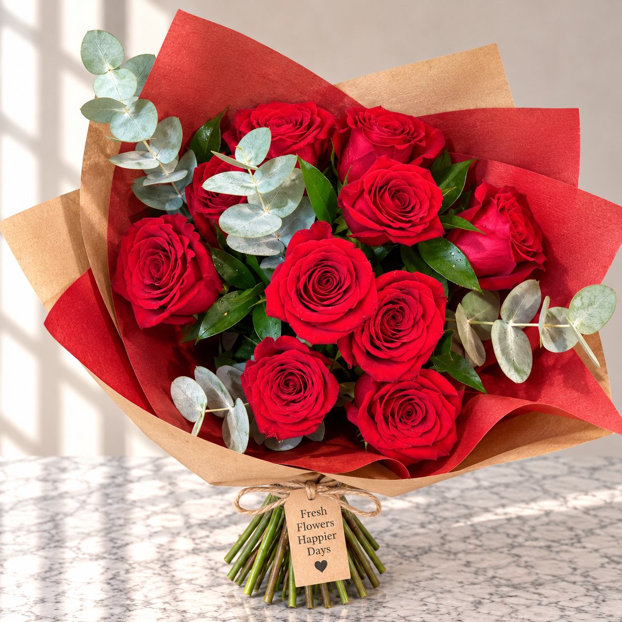 Red roses and eucalyptus wrapped in red and kraft paper