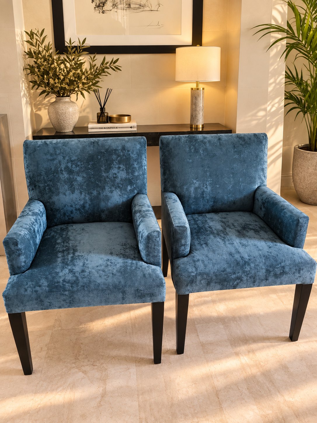 Two of the dining chairs, reupholstered in teal crushed velvet